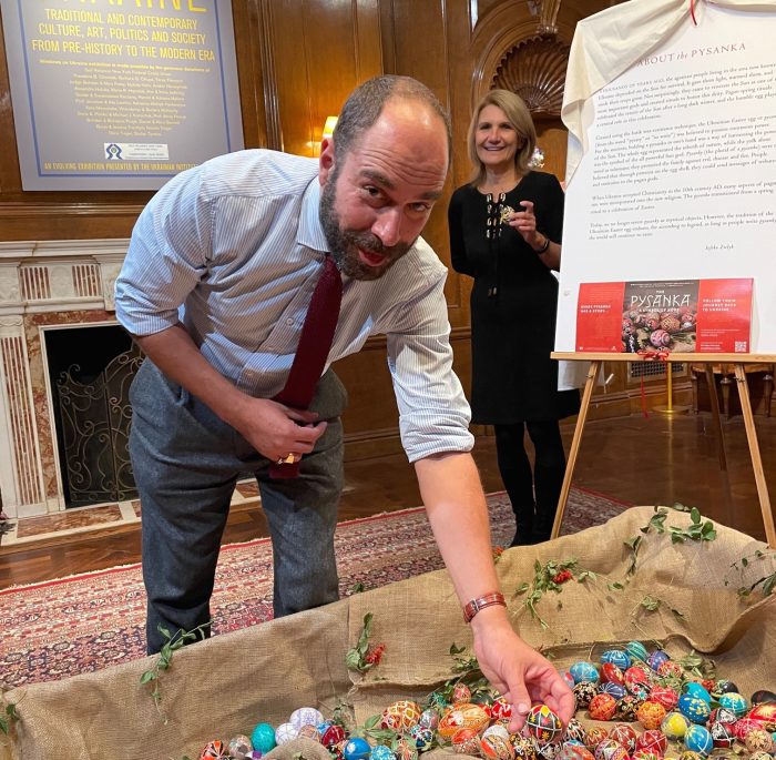 Xavier F. Salomon, Deputy Director and Peter Jay Sharp Chief Curator at the Frick Collection in New York, adding his own pysanka to the installation as Kathy Nalywajko, President of the UIA looks on.