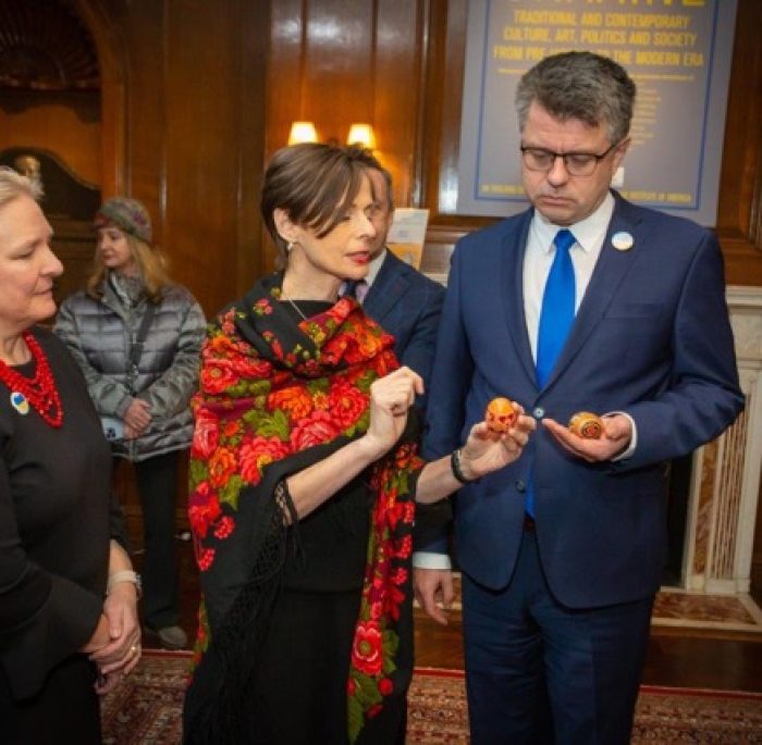 Foreign Minister of Estonia, Mr. Urmas Reinsalu, holding two pysanky which he personally brought from Estonia to add to the installation. Lydia Zaininger, Director of the UIA looks on